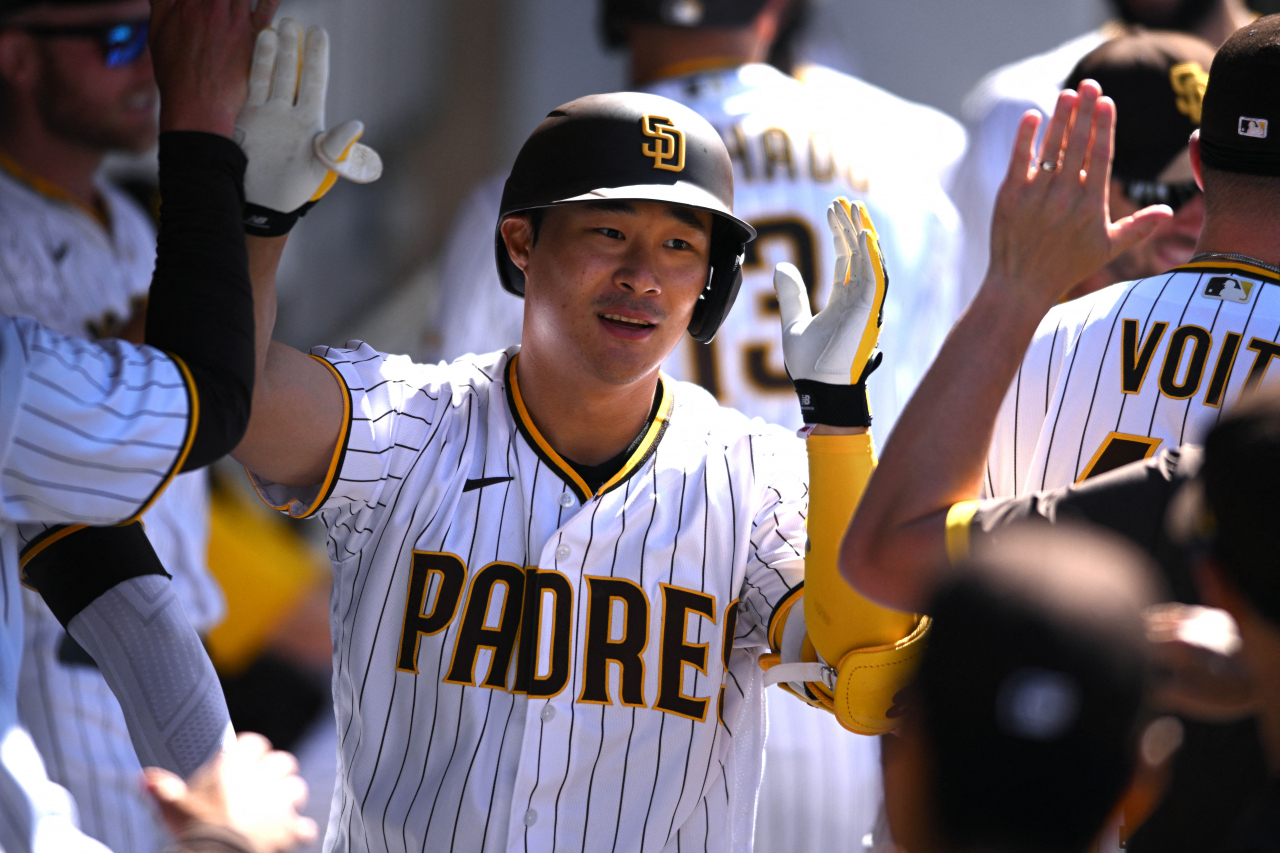 In this USA Today Sports photo via Reuters, Kim Ha-seong of the San Diego Padres (C) is congratulated by teammates in the dugout after hitting a solo home run against the Cincinnati Reds during the bottom of the seventh inning of a Major League Baseball regular season game at Petco Park in San Diego on Wednesday. (Reuters)