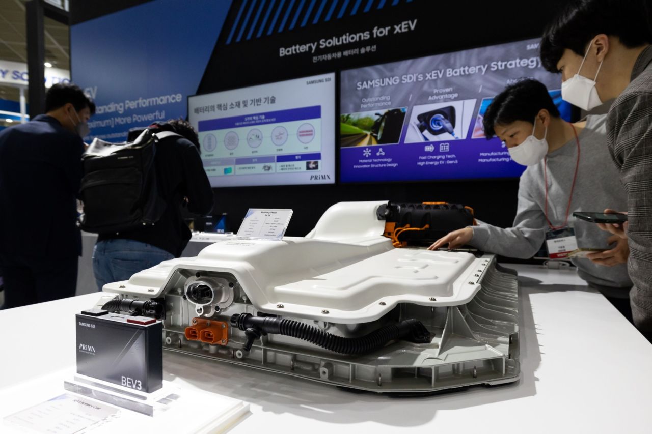 Attendees look at a Samsung SDI battery pack for electric vehicles displayed at the InterBattery exhibition in Seoul in March. (Bloomberg)