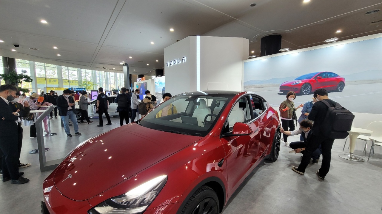 Visitors at the International Electric Vehicle Expo look at Tesla vehicles on display at the Jeju Convention Center on Jeju Island on Tuesday. (IEVE)