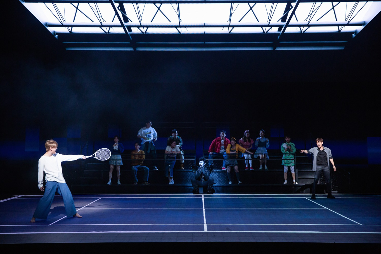 L, played by Kim Jun-su (left), faces Light, played by Ko Eun-sung, in a tennis match scene that uses LED technology to create various perspectives and angles of the match. (OD Company)