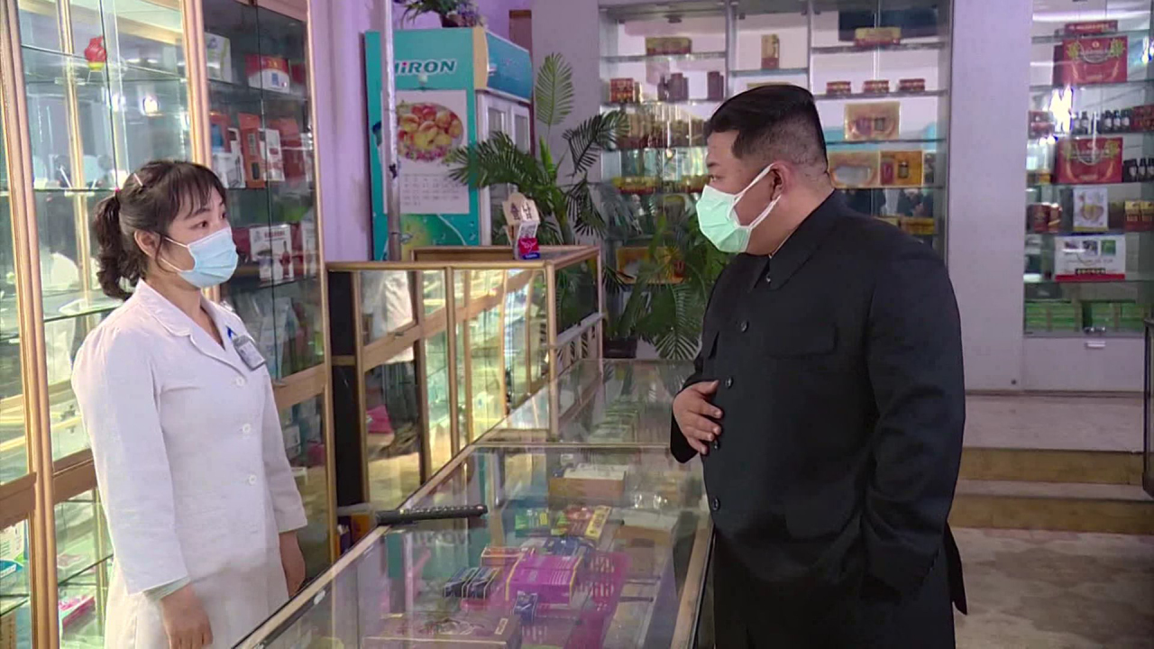 In this footage released Monday by the Korean Central Television, North Korean leader Kim Jong-un was seen wearing a blue surgical mask on top of a white mask of an unknown material. (Yonhap)