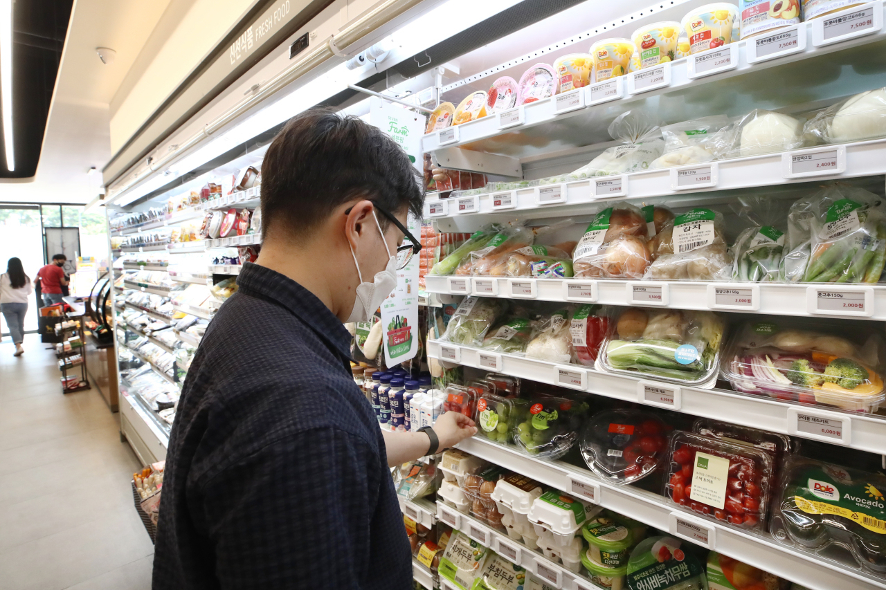 A customer looks at items at a convenience store in Seoul. (Yonhap)