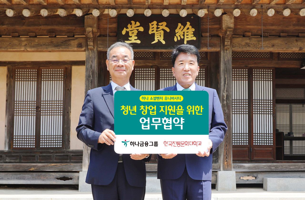 Hana Financial Group Chairman Ham Young-joo (right) and Korea National University of Cultural Heritage President Kim Young-mo pose for a photo at the partnership signing ceremony held at the KNUCH in Buyeo, South Chungcheong Province on Friday. (Hana Financial Group)