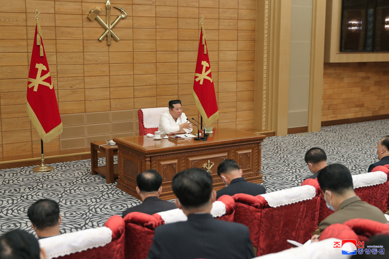 This photo, released by the state-run Korean Central News Agency on Sunday, shows North Korean leader Kim Jong-un holding a politburo meeting of the ruling Workers' Party of Korea to discuss anti-COVID-19 measures. (Yonhap)