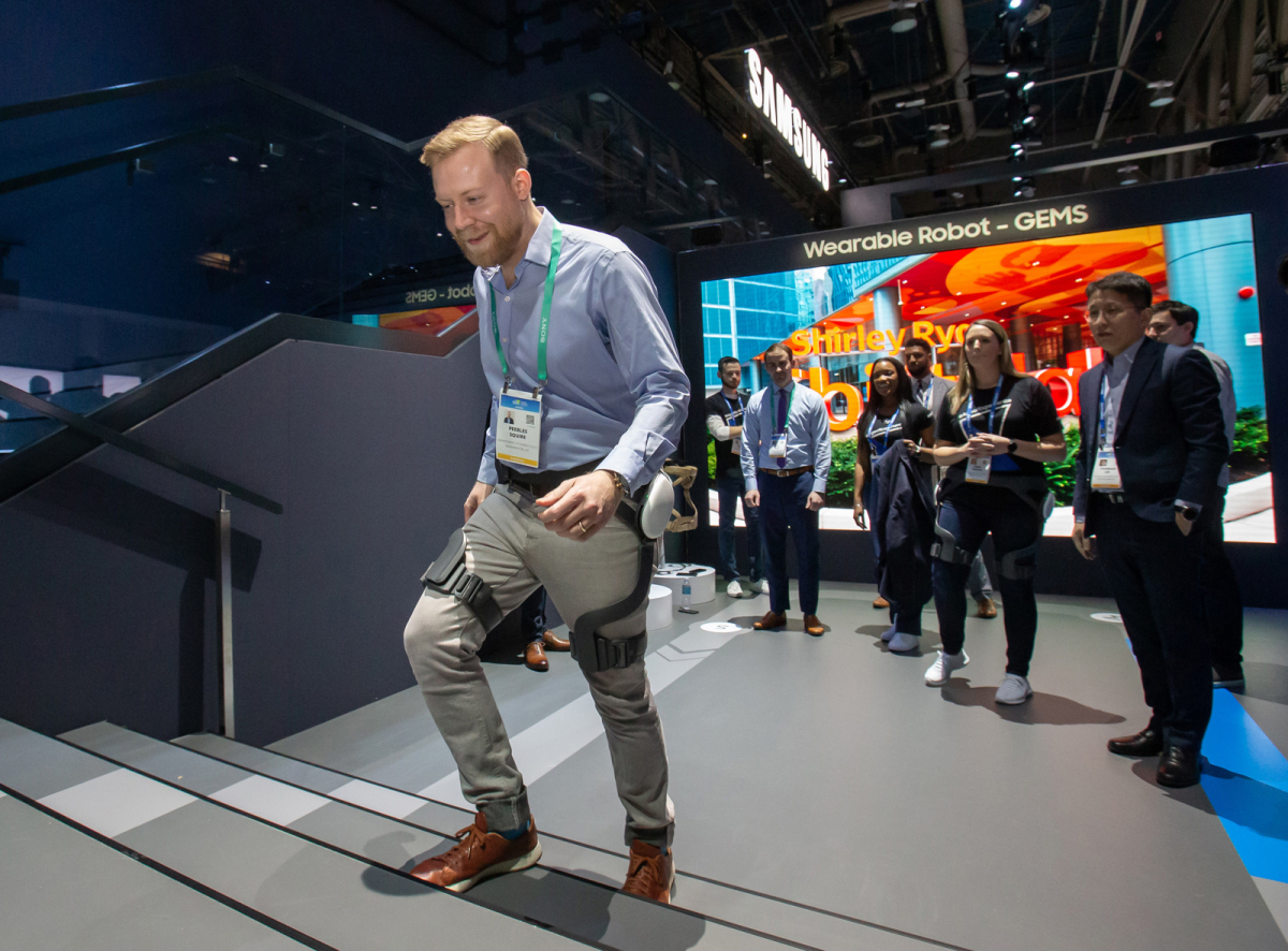 Samsung Electronics’ wearable robot is tried by a visitor at the Consumer Electronics Show in 2020. (Samsung Electronics)