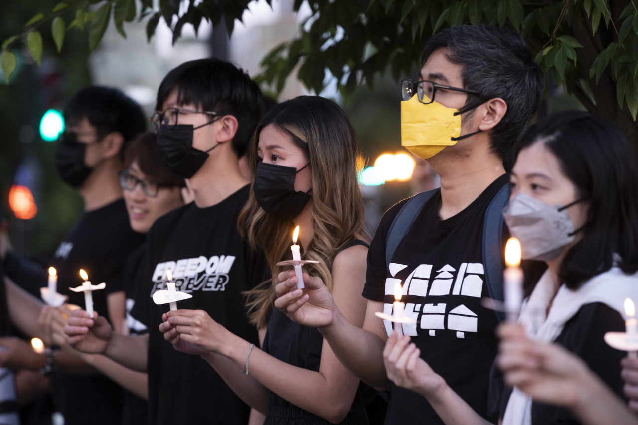 People attend a candlelight vigil and ceremony of remembrance to mark the 33rd anniversary of the 1989 Tiananmen Square Massacre, at the Victims of Communism Memorial in Washington, Friday. (EPA)