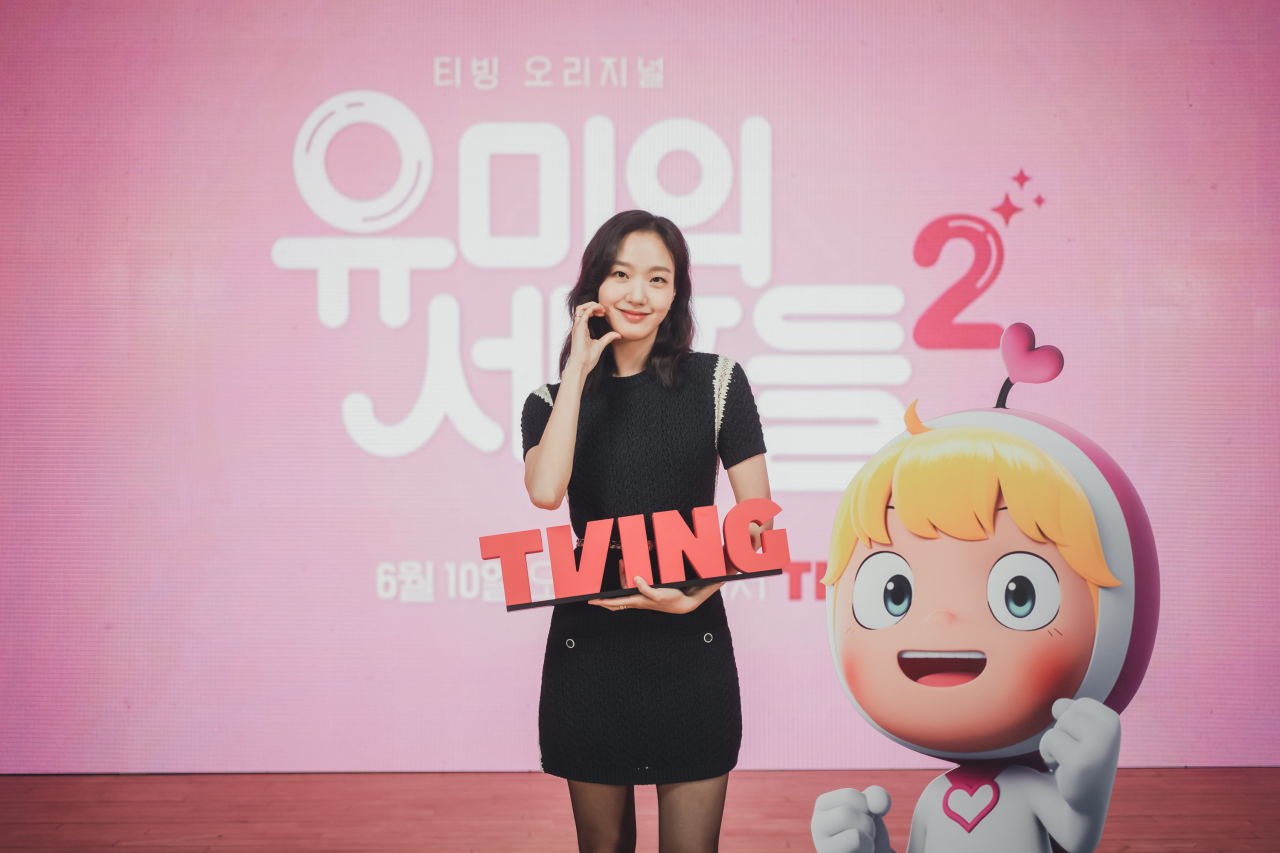 Kim Go-eun poses for photos before an online press conference Tuesday. (Tving)