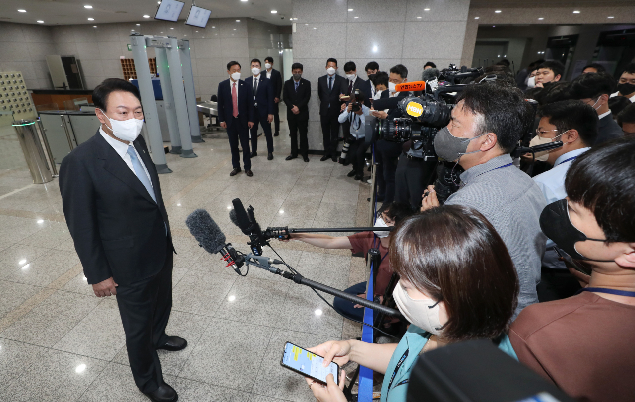 President Yoon Suk-yeol takes reporters' questions as he arrives for work at the presidential office in Seoul on Friday. (Yonhap)