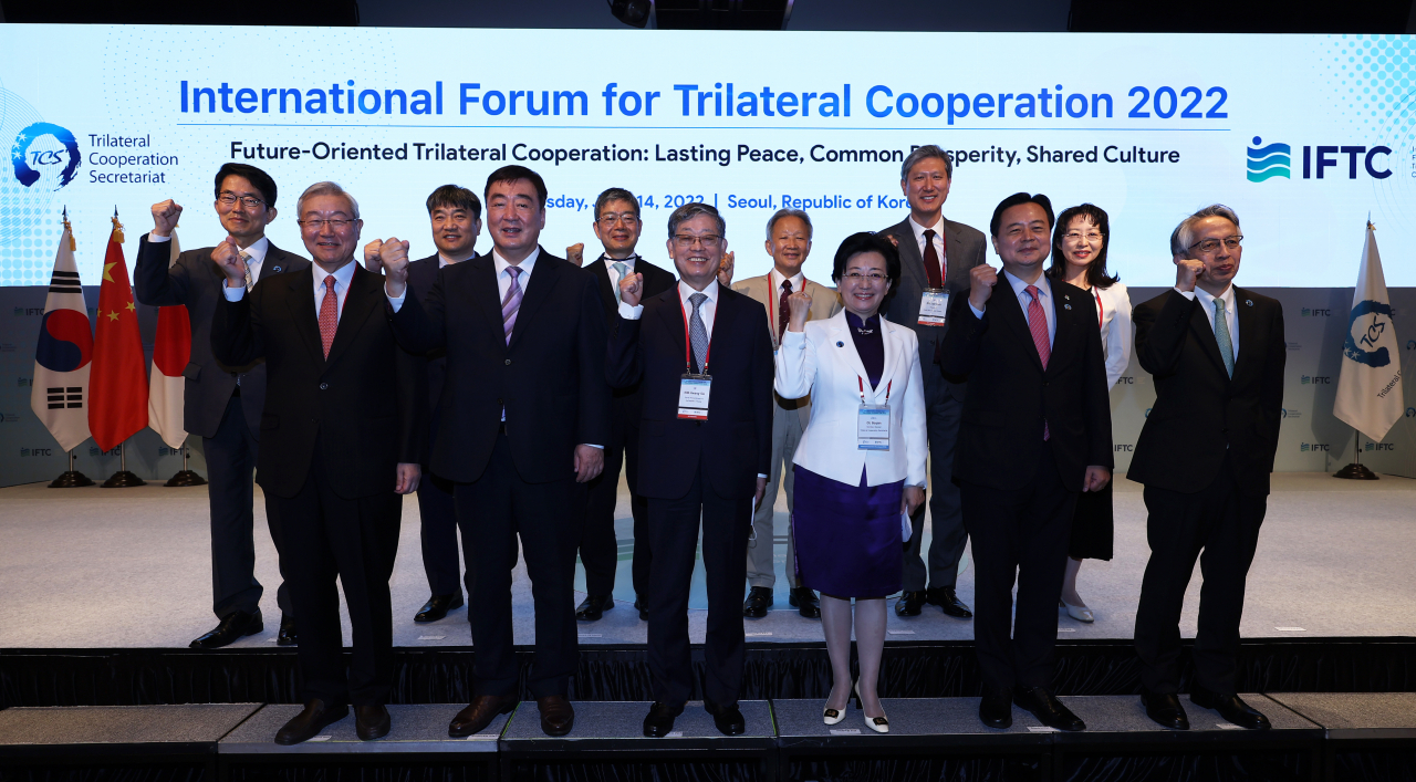 Participants of the International Forum on Trilateral Cooperation 2022 pose for a photo during a session held at a hotel in Seoul on Tuesday. (Yonhap)