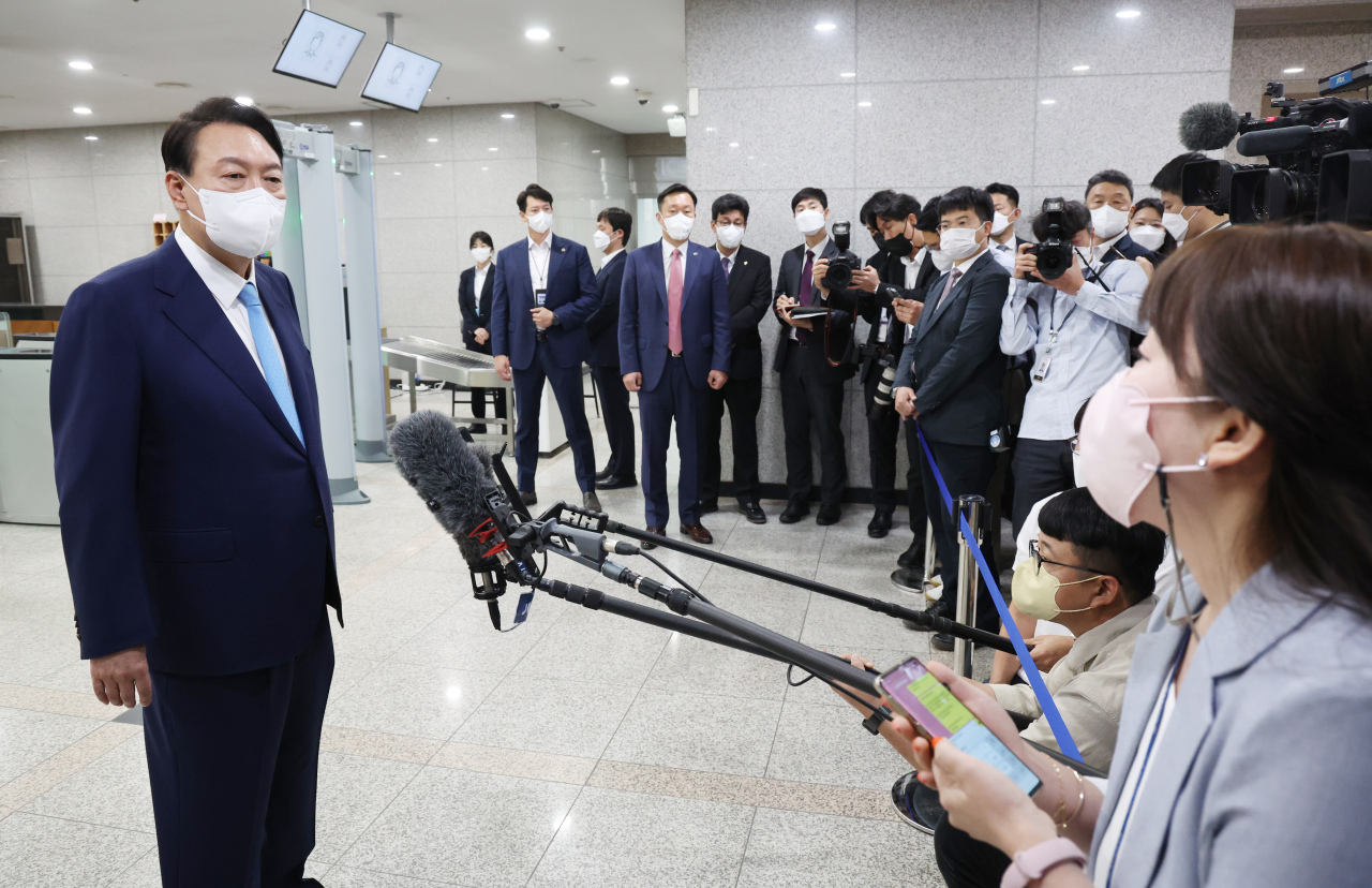 President Yoon Suk-yeol speaks to reporters on his way to the presidential office in Seoul on Tuesday. (Yonhap)
