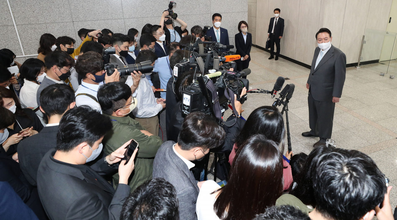 President Yoon Suk-yeol takes reporters' questions as he arrives at the presidential office in Seoul on Wednesday. (Yonhap)
