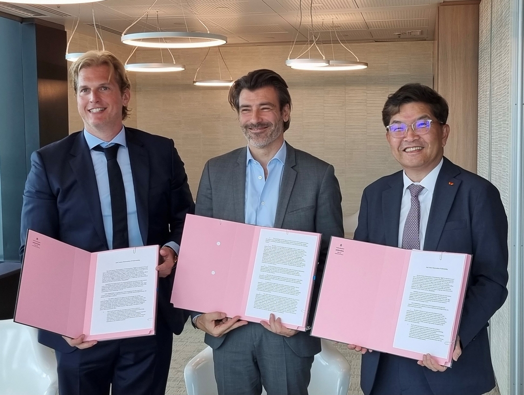 (From L to R) Daniel Solomita, founder and CEO of Loop Industries; Max Pellegrini, deputy CEO of Suez Group; and Na Kyung-soo, CEO of SK Geocentric, pose for a photo at the Suez headquarters in France on June 7, 2022, after signing an agreement on a plastic recycling joint venture, in this photo provided by SK Geocentric on June 16. (SK Geocentric)