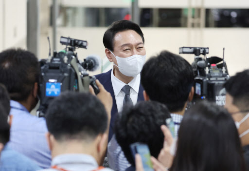 President Yoon Suk-yeol answers reporters' questions while reporting for work at his office in Seoul on Friday. (Yonhap)