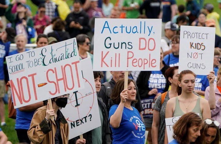 Demonstrators hold placards as they take part in March for Our Lives, one of a series of nationwide protests against gun violence, in Washington, DC, June 11. (Reuters)