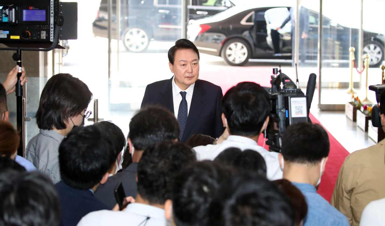 Yoon speaks to reporters at the lobby of the presidential office in Yongsan on Tuesday morning. (Yonhap)