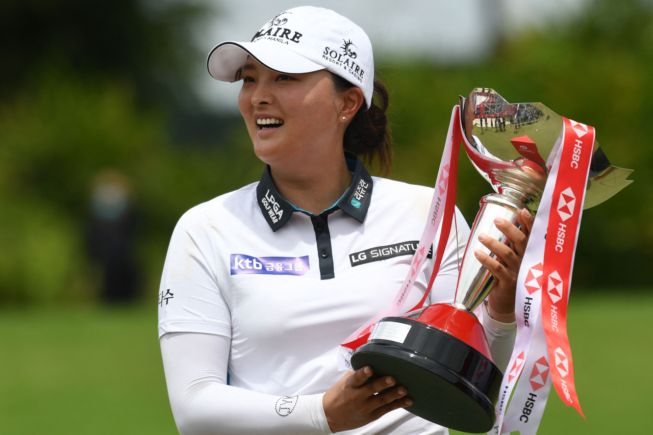In this Associated Press file photo from March 6, 2022, Ko Jin-young of South Korea hoists the champion's trophy after winning the HSBC Women's World Championship at Sentosa Golf Club's Tanjong Course in Singapore. (AP)