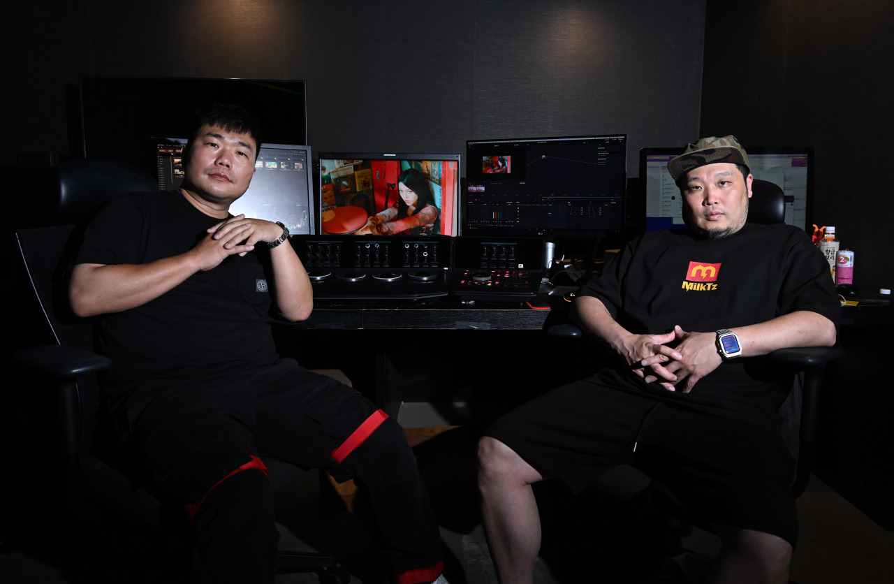 Kim Jun-hong (left) and Hong Won-ki, co-CEOs and co-founders of Zanybros, pose for photos during an interview with The Korea Herald at the K-pop music video production company’s headquarters in southern Seoul. (Im Se-jun/The Korea Herald)