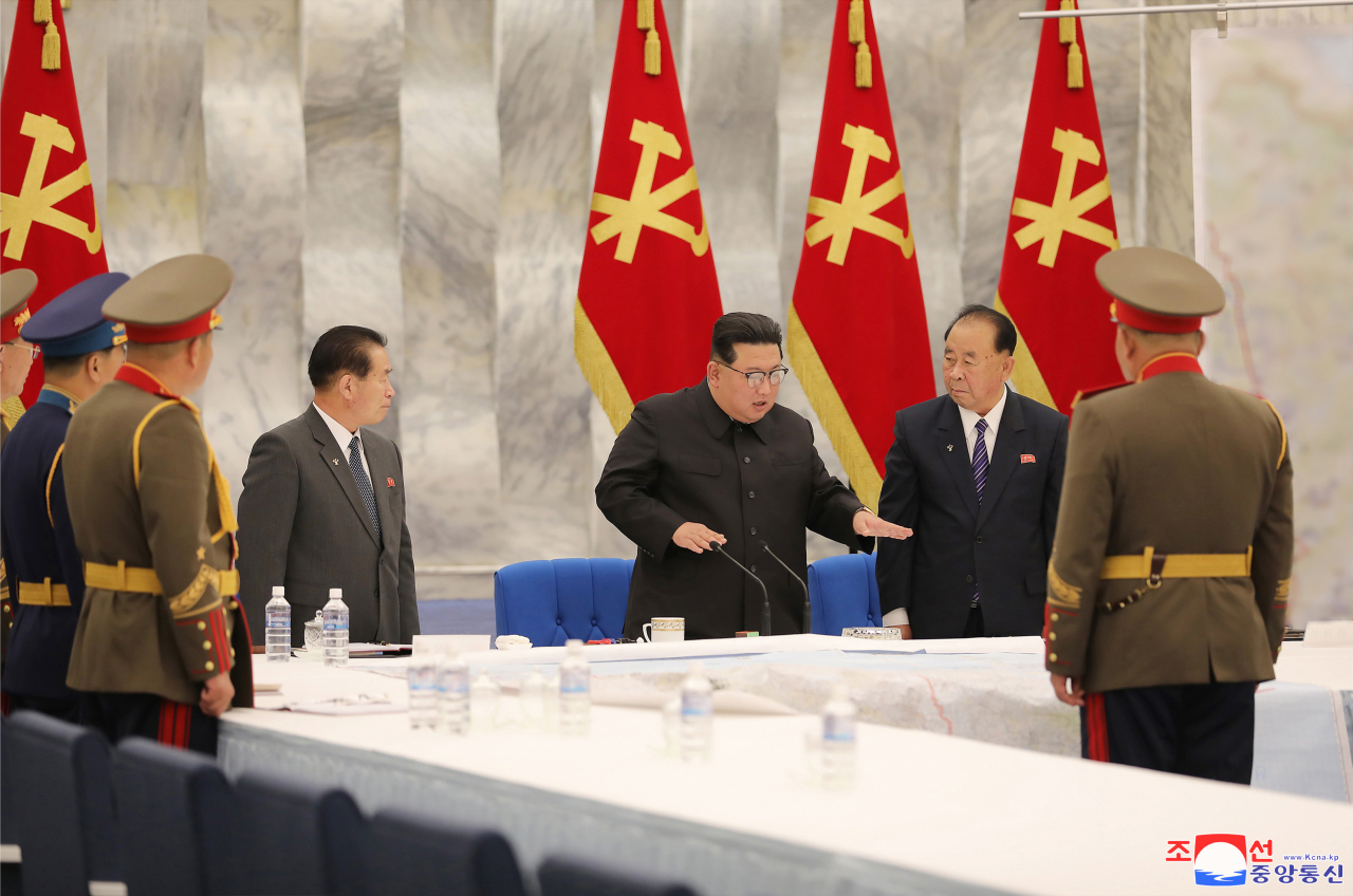 North Korean leader Kim Jong-un (3rd from R) speaks during the second sitting of the third enlarged meeting of the eighth Central Military Commission of the ruling Workers' Party in Pyongyang on Wednesday, to discuss revising operation plans of its front-line units, in this photo released by the official Korean Central News Agency the following day. (KCNA)