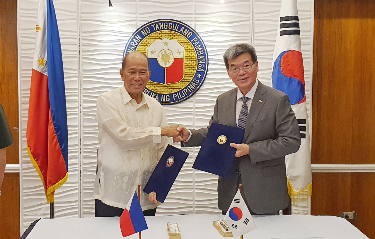 (From left) Secretary of National Defense of the Philippines Delfin N. Lorenzana and Korea Shipbuilding and Offshore Engineering President Ka Sam-hyun shake hands after signing an OPV contract on Monday. (HHI)