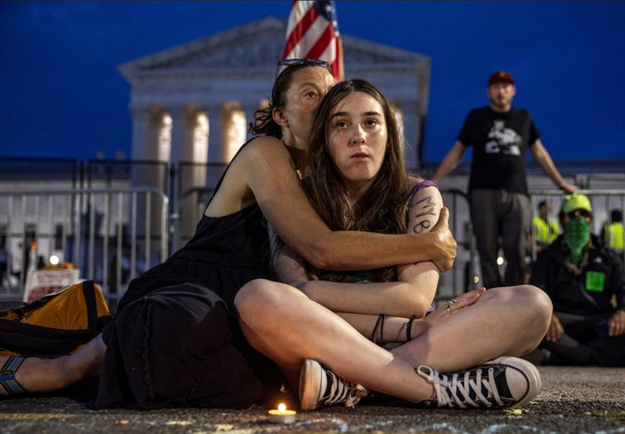 (Lisa Turner,47, holds her daughter Lucy Kramer,14, during a candlelight vigil after the United States Supreme Court ruled in the Dobbs v Women's Health Organization abortion case, overturning the landmark Roe v Wade abortion decision, outside the United States Supreme Court in Washington last Sunday.(REUTERS/Evelyn Hockstein)
