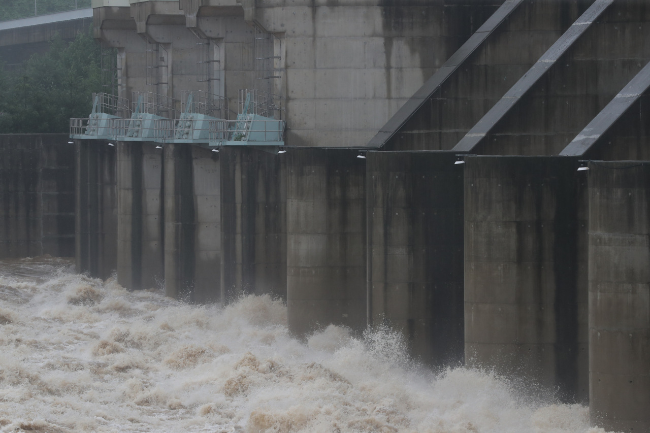 Water pours out of floodgates at Gunnam Dam in Yeoncheon, 62 kilometers north of Seoul, on Wednesday. (Yonhap)