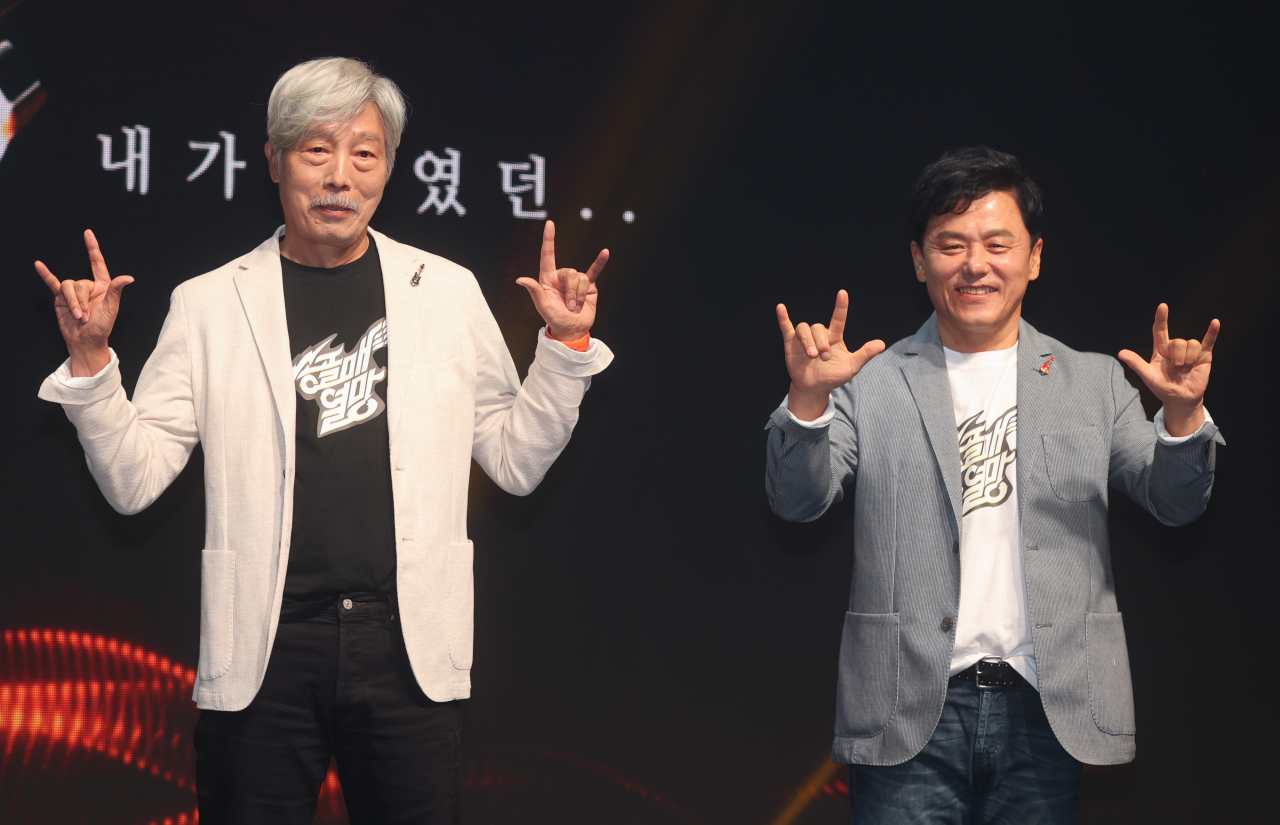 Renowned rock band musicians Bae Cheol-soo (left) and Koo Chang-mo pose for photos during a press event for the band’s upcoming nationwide concert tour “Songolmae Live Tour 2022” in Hapjeong-dong, western Seoul, Wednesday. (Yonhap)