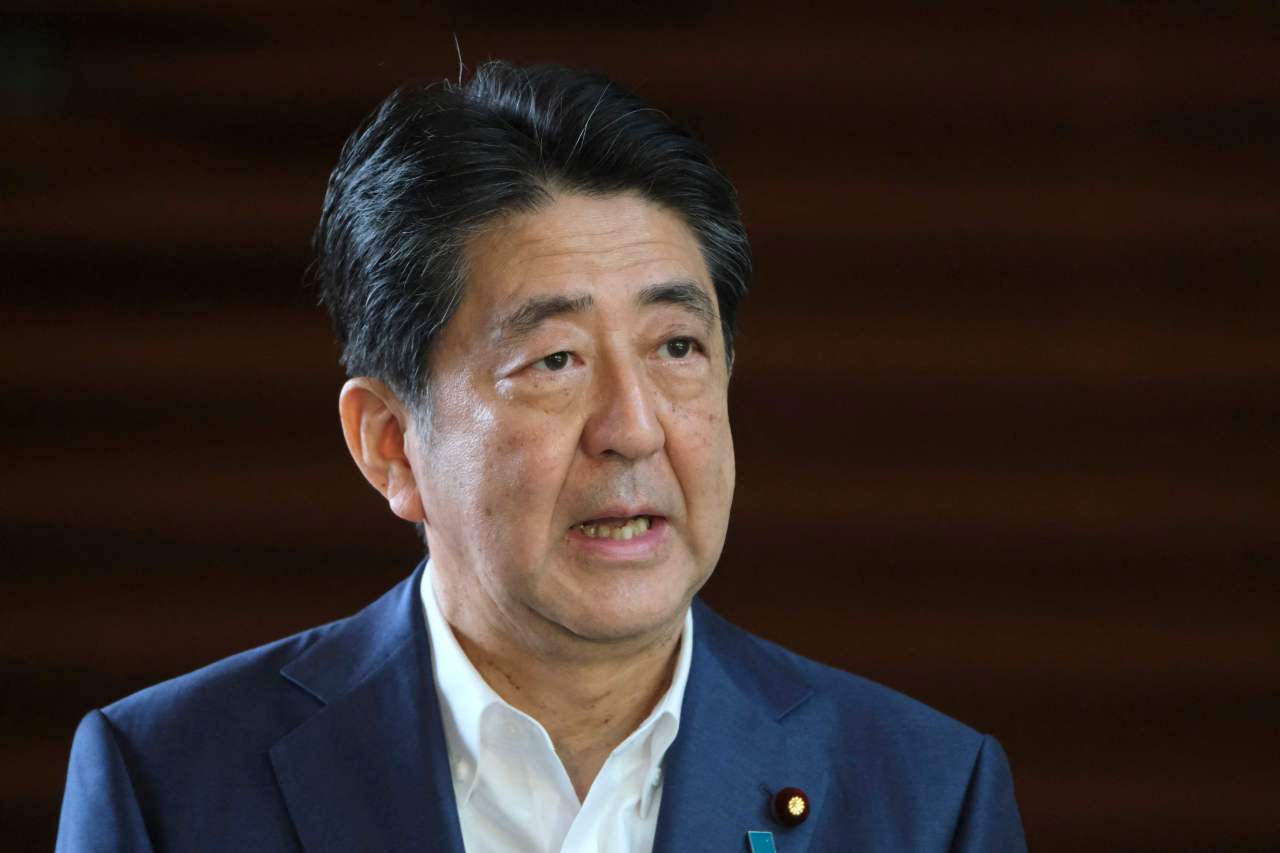 In this file photo taken on August 24, 2020, Japan`s Prime Minister Shinzo Abe speaks to the media upon his arrival at the prime minister`s office. - Former Japanese prime minister Shinzo Abe was attacked and left bleeding at a campaign event in the Nara region on July 8, 2022, local media reported. (Photo by Kazuhiro NOGI / AFP)