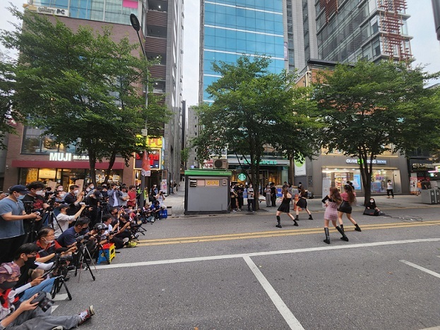 Four female idol trainees from a local entertainment agency TIM perform cover dances of hit K-pop songs on a street near Hyundai Department Store.