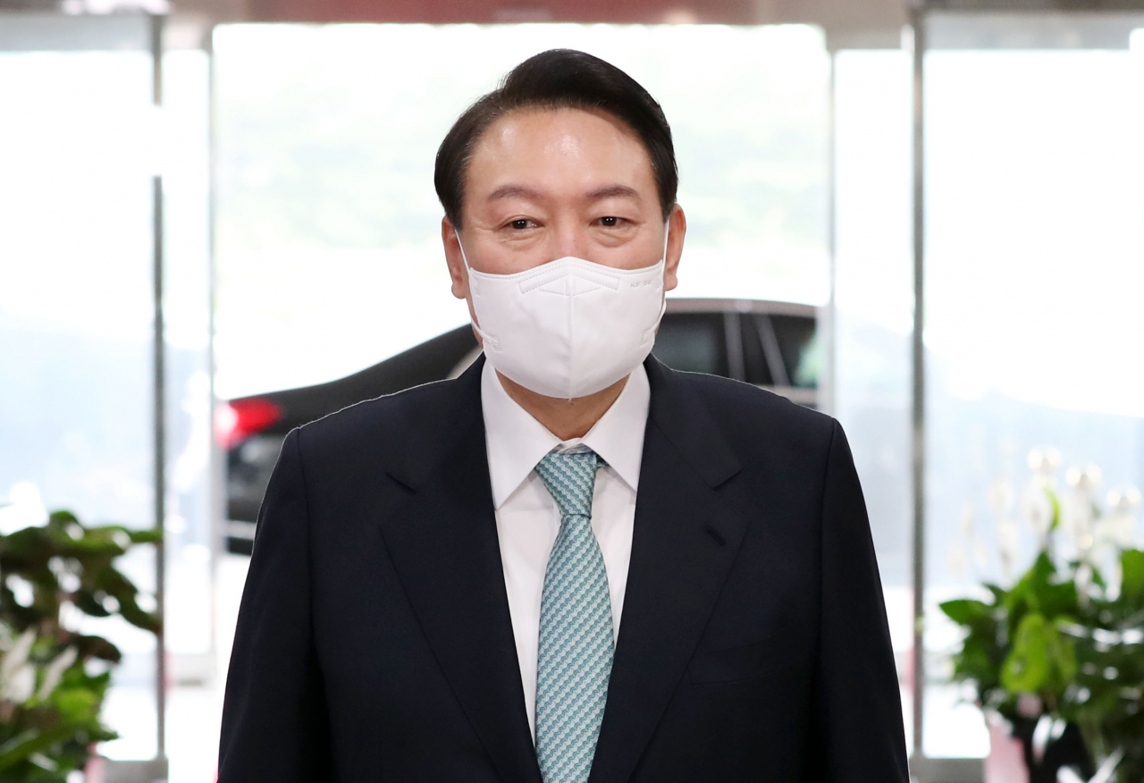 President Yoon Suk-yeol takes reporters' questions as he arrives at his office in Seoul on Thursday. (Yonhap)