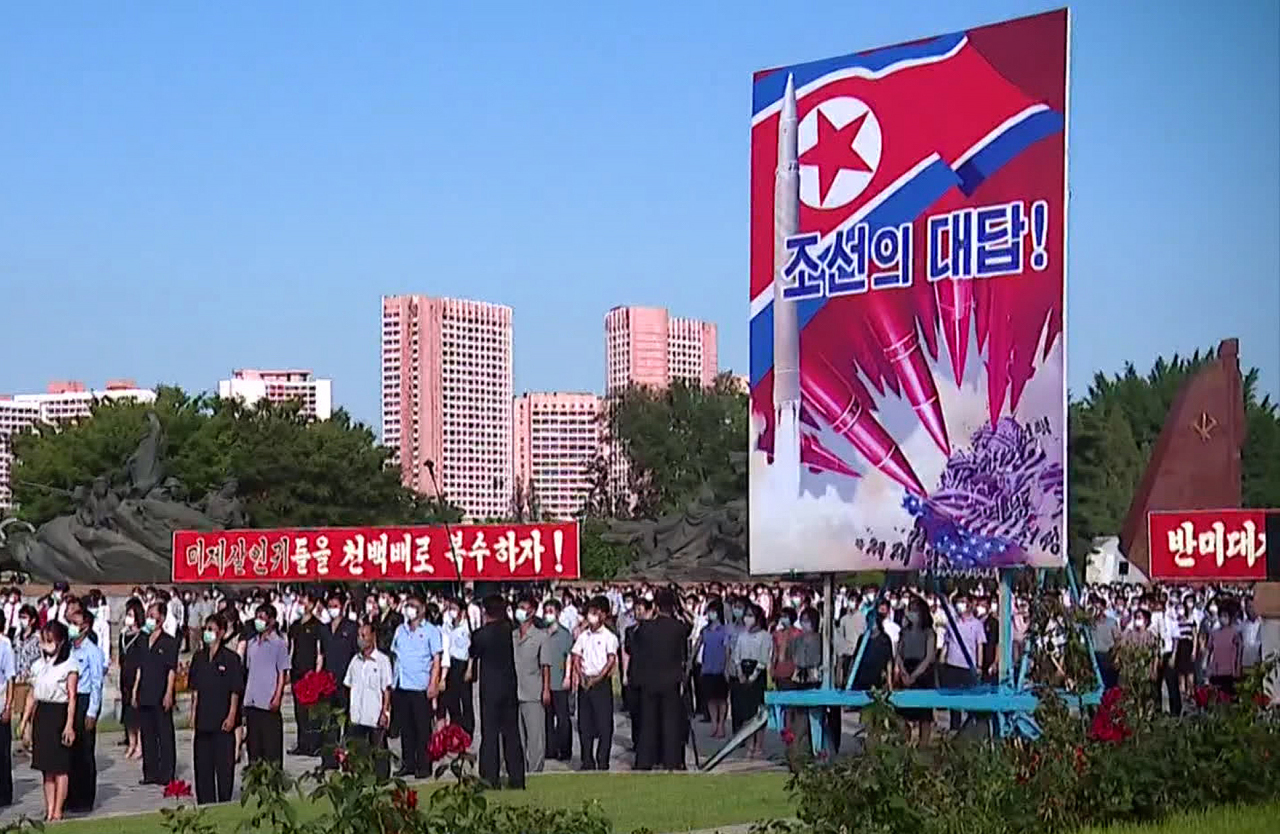 This photo, captured from a clip from North Korea`s Central TV, shows an anti-American youth rally in Pyongyang on June 25, 2022, with a propaganda painting depicting North Korean ICBMs striking the U.S. Capitol. The rally took place on the occasion of the 72nd anniversary of the Korean War. (Yonhap)