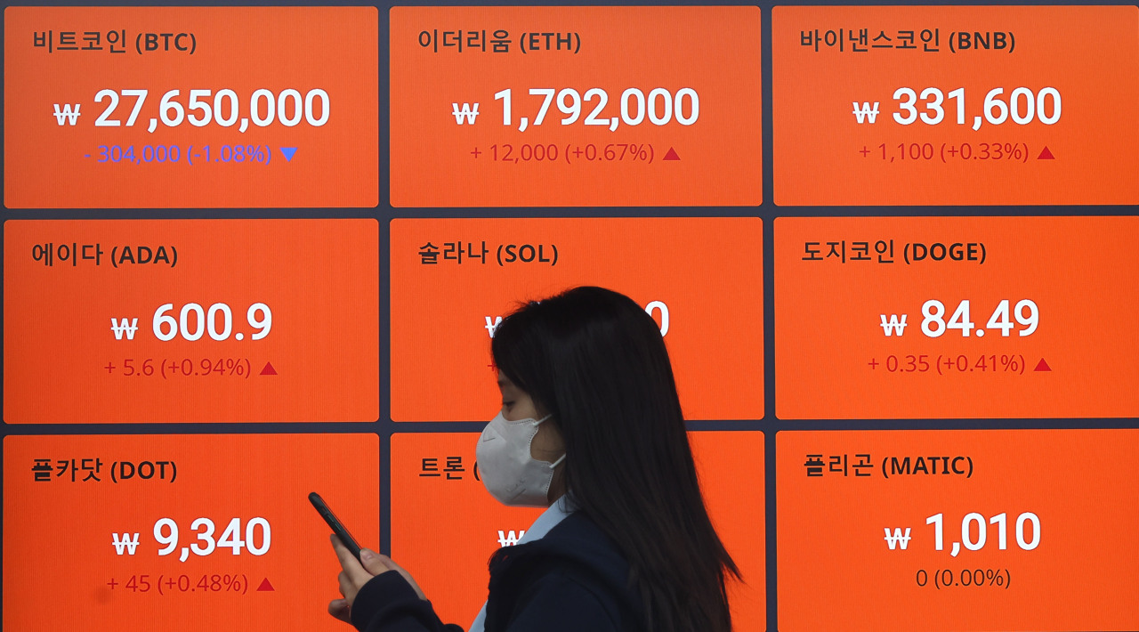 Electronic boards at Bithumb customer center in Seoul show different cryptocurrency prices. (Yonhap)