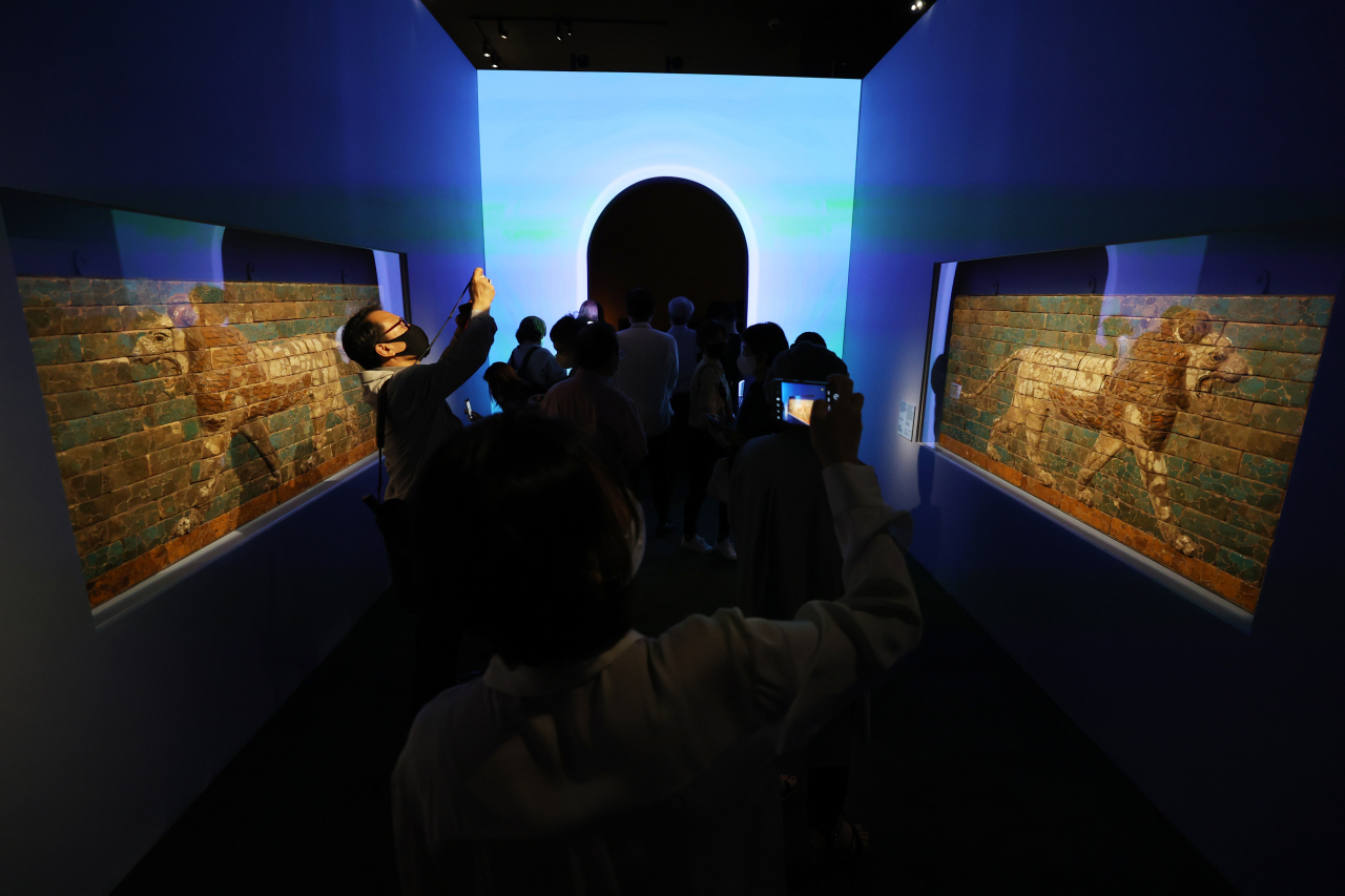 Visitors view “Panel with Striding Lion,” during a preopening event for “Mesopotamia: Great Cultural Innovations, Selections from The Metropolitan Museum of Art” at the National Museum of Korea, in Seoul, July 21. (Yonhap)