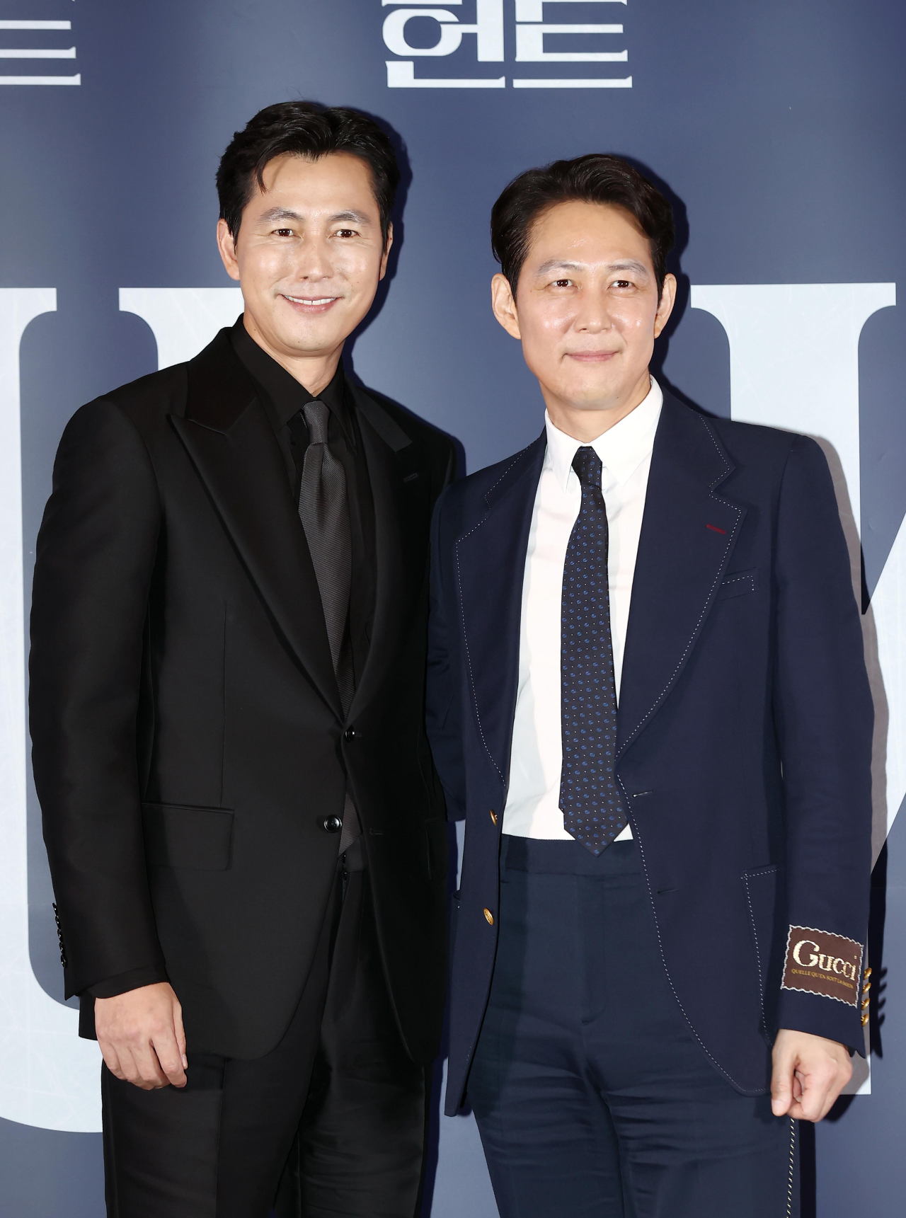 Jung Woo-sung (left) and Lee Jung-jae pose for photos after a press conference held at Megabox Coex in Seoul on Wednesday. (Yonhap)