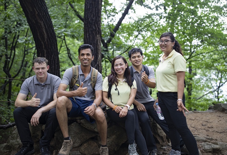 A group of foreign hikers decked out in rented hiking outfits pose for a photo on a trail in Bukhansan National Park. (Seoul Tourism Organization)