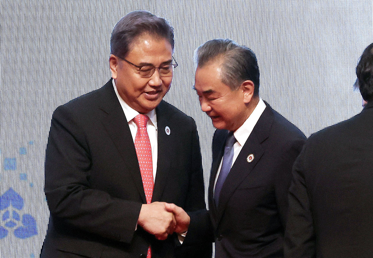 South Korean Foreign Minister Park Jin shakes hands with his Chinese counterpart, Wang Yi, at the ASEAN Plus Three meeting held in Phnom Penh, Cambodia, on Thursday. (Yonhap)