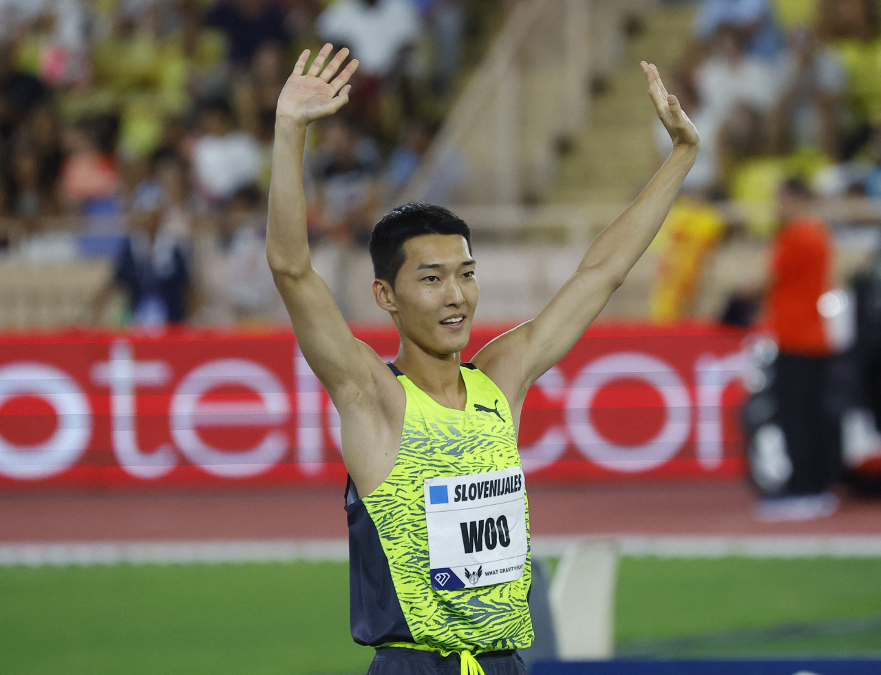 In this Reuters photo, Woo Sang-hyeok of South Korea celebrates a successful attempt during the men's high jump competition at the Diamond League at Stade Louis II in Monaco on Wednesday. (Reuters)