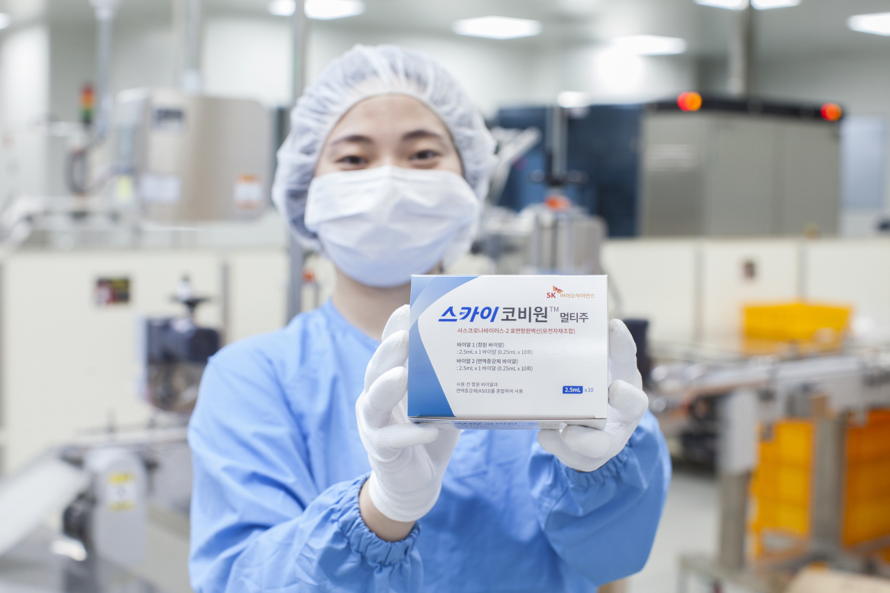 A researcher holds up the final package product of SKYCovione (SK Bioscience)