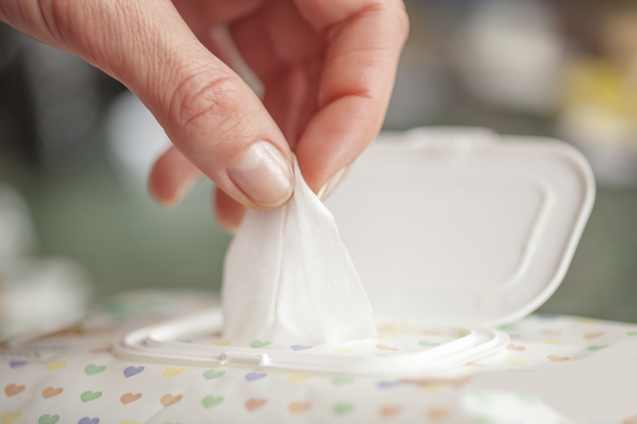 A person picks a wet wipe from a package box. (123rf)