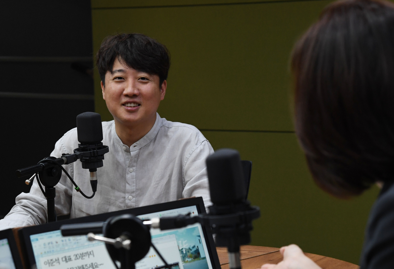 Lee Jun-seok, the suspended chief of the ruling People Power Party (PPP), smiles during a radio talk show on Monday. (Yonhap)