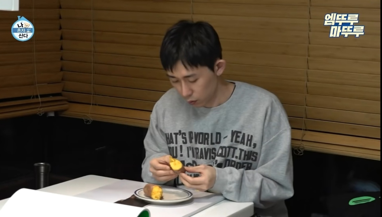 Music producer Code Kunst eats a sweet potato during the MBC TV show 