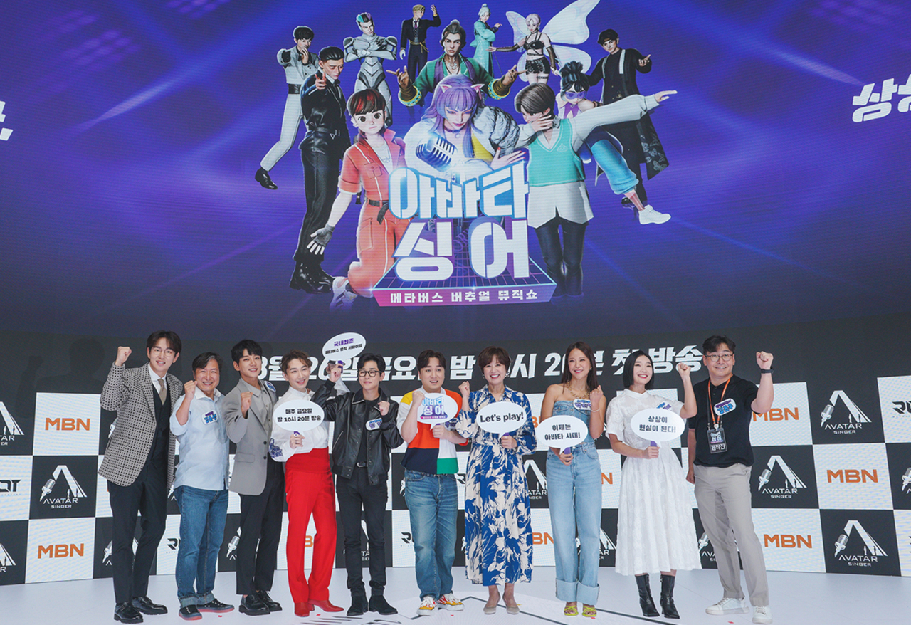 From left: TV host and personality Jang Sung-kyu, Root M&C’s chief operating officer Kim Yun-sung, singer Hwang Chi-yeul, musical actor Kim Ho-young, rapper DinDin, comedian Hwang Je-sung, comedian Park Mi-sun, singer Baek Ji-young, Lip J of female dance crew Prowdmon and chief producer Kim Don-woo pose for photos during a press conference for MBN‘s upcoming metaverse-based music survival show “Avatar Singer” held in Hanam, Gyeonggi Province, Thursday. (MBN)