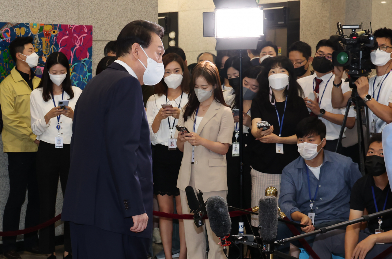 President Yoon Suk-yeol answers reporters' questions while arriving for work at the presidential office in Seoul on Tuesday. (Yonhap)