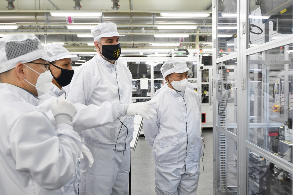 Samsung SDI CEO Choi Yoon-ho (R) and Indiana Gov. Eric Holcomb (2nd from R) look at the battery production line at Samsung SDI's Cheonan complex on Thursday, in this photo provided by the South Korean battery maker the following day. (Samsung SDI)