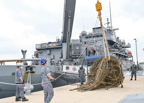 This undated photo, provided by the Navy, shows a Navy vessel engaging in a maritime waste removal operation. (Navy)