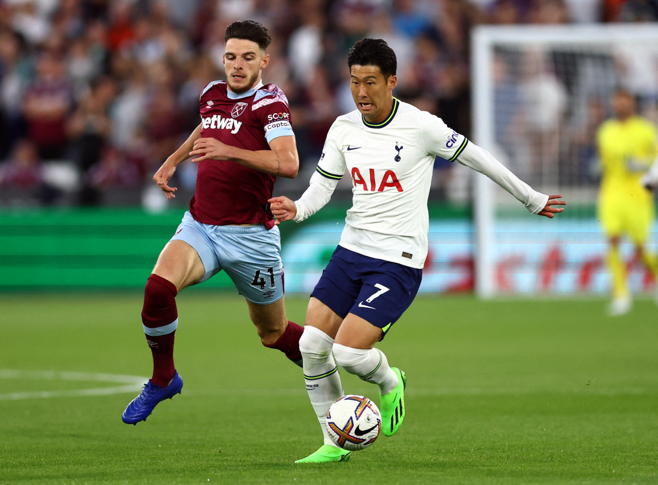 In this Reuters photo, Son Heung-min of Tottenham Hotspur (R) battles Declan Rice of West Ham United for the ball during the clubs' Premier League match at London Stadium in London on Wednesday. (Reuters)