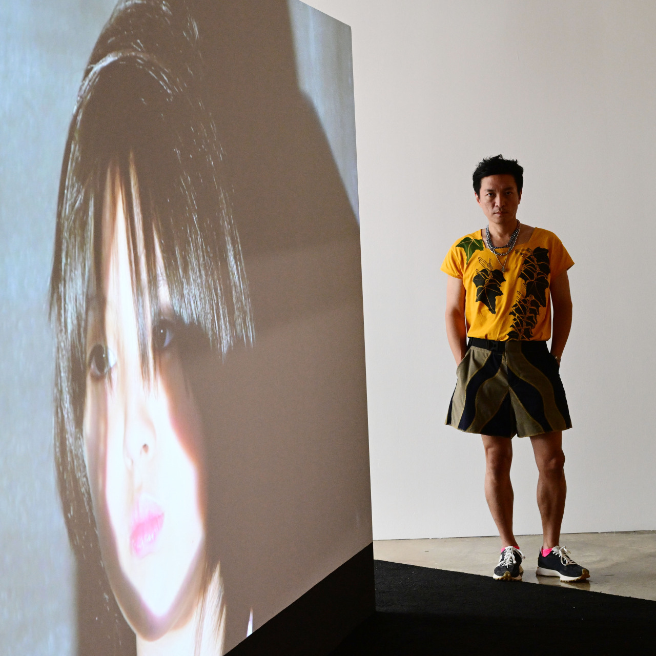 Kim Sung-hwan poses next to his video installation work 