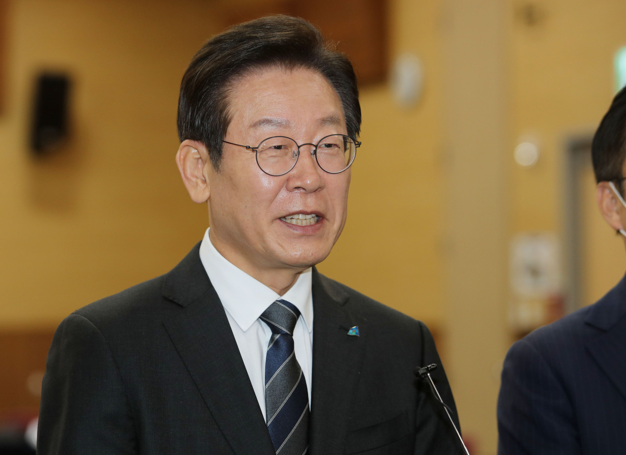 Rep. Lee Jae-myung, chairman of the Democratic Party of Korea, answers reporters' questions at the Kimdaejung Convention Center in Gwangju, Friday. (Yonhap)