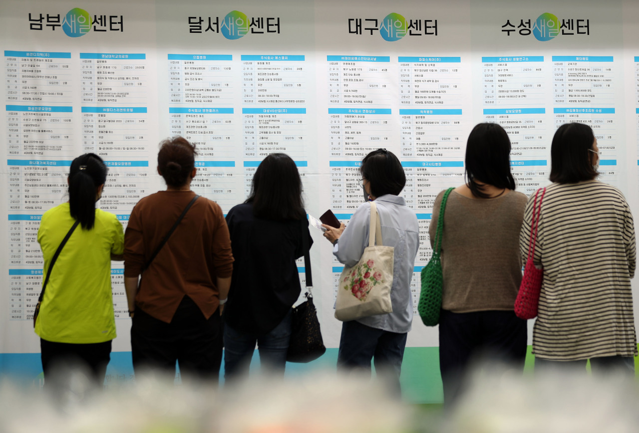 Job seekers look at employment information at a job fair held at a convention center in Daegu on Friday. (Yonhap)