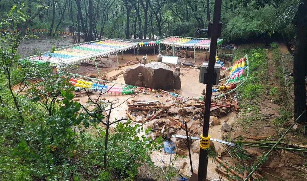 The Gulbulsa Temple Site in Gyeongju, North Gyeongsang Province, after a mudslide on Tuesday. (Yonhap). Seen in the middle is the National Treasure No. 121, Stone Buddhas in Four Directions.
