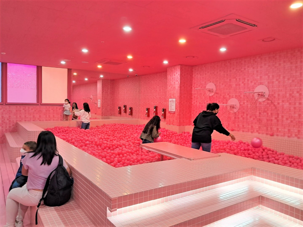 Visitors play in the ball pool named Pink Spa at Color Pool Museum. (Lee Si-jin/The Korea Herald)
